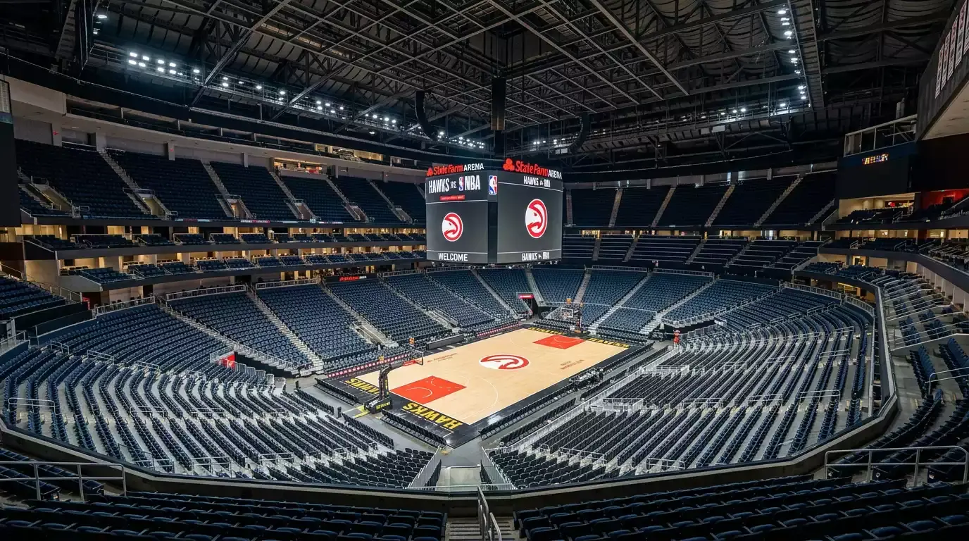 Empty NBA basketball arena viewed from the upper stands showing the polished hardwood court and arena lighting